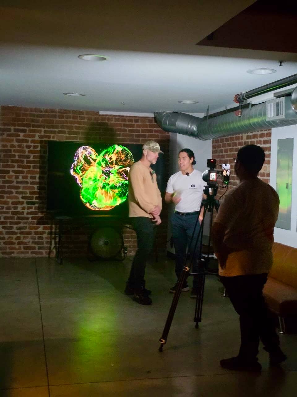 Filming a conversation in front of the lounge screen